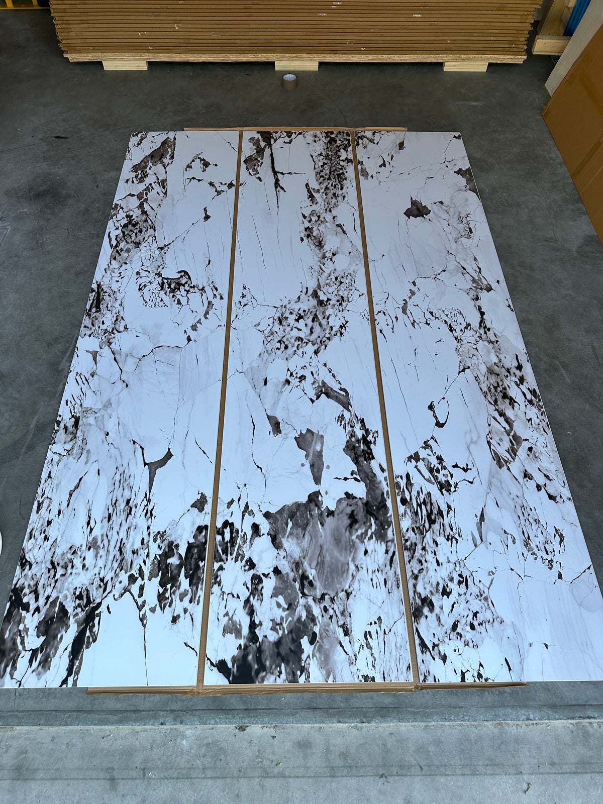 Three Calcatta Viola SPC panels laid side by side before installation